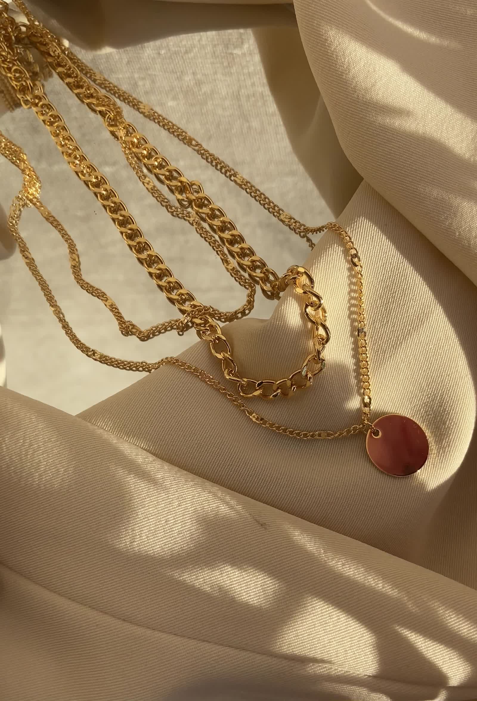 Gold jewelry on cream fabric